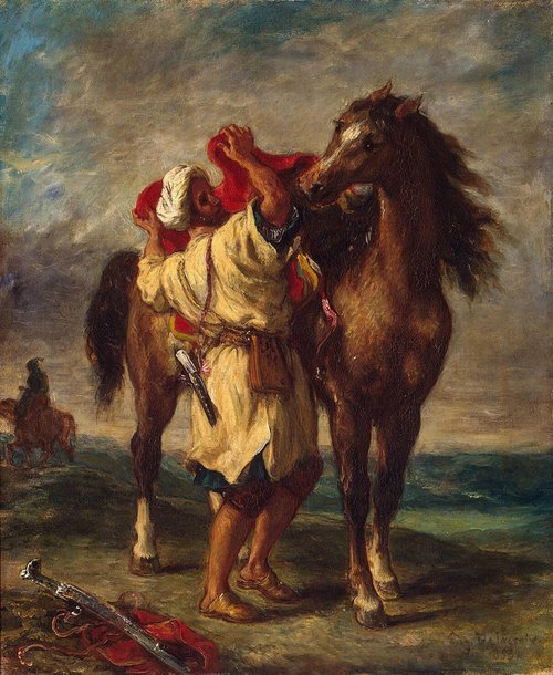 Arab saddling his horse