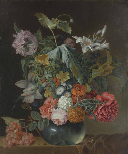 Flowers in a vase with grapes