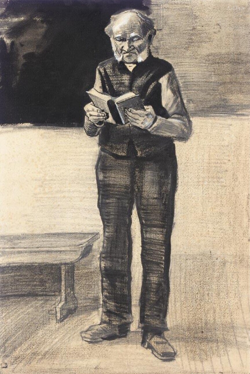 A man standing and reading